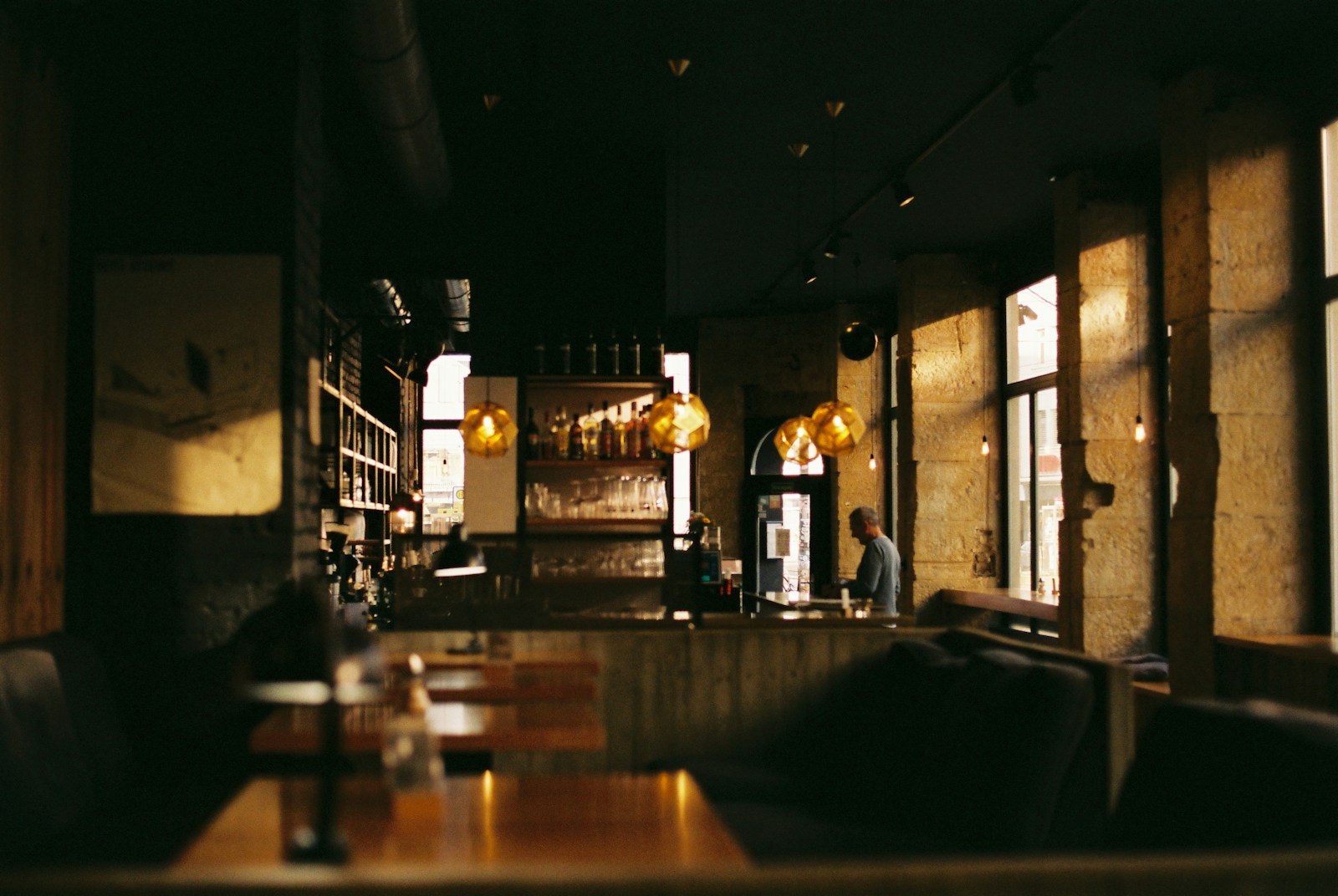 Warm ambient lighting and beautifully set tables in a contemporary dining room